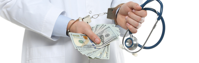 Image of Doctor in handcuffs with bribe and stethoscope on white background, closeup. Banner design