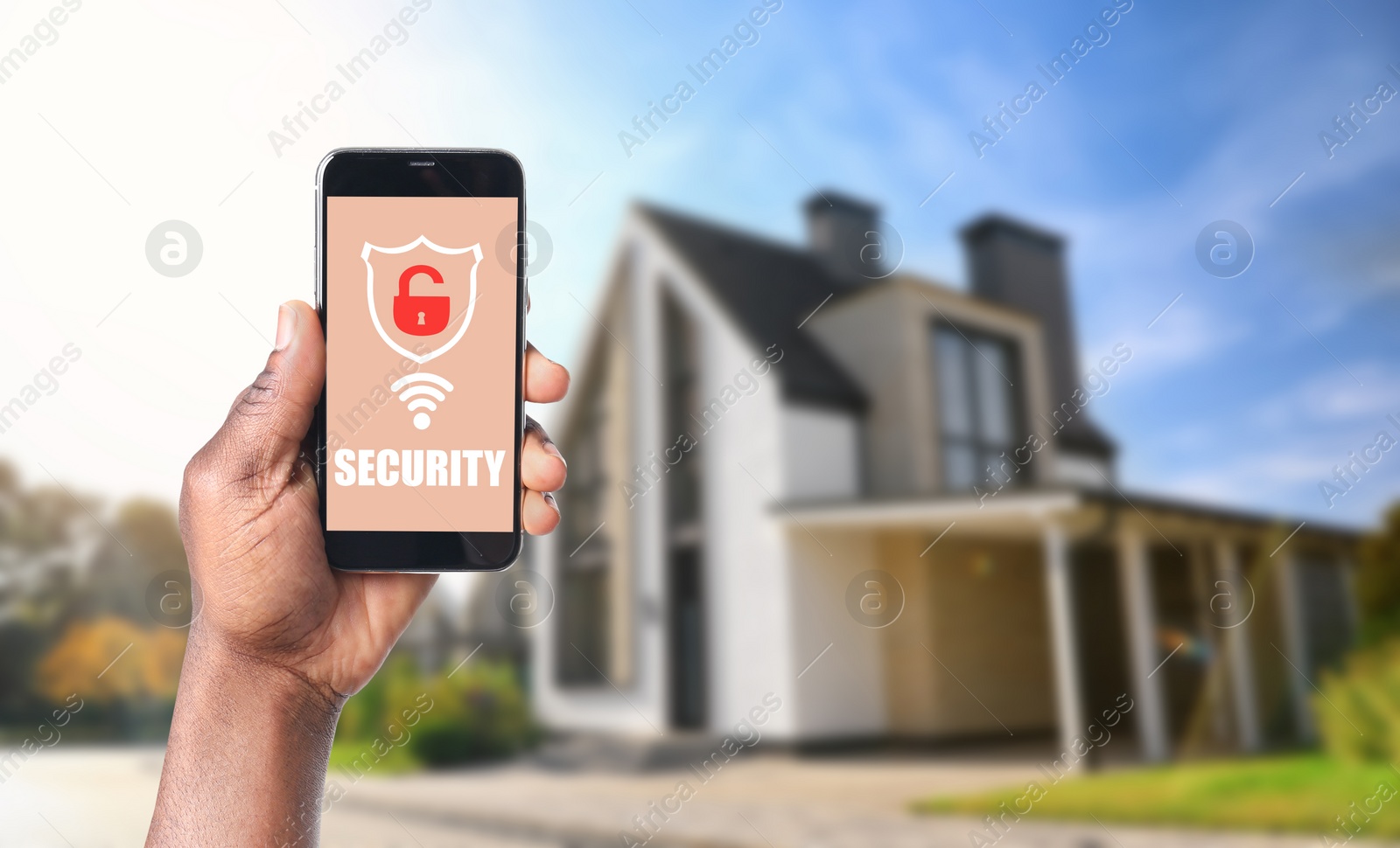 Image of Alarm system. African-American man using phone outdoors, space for text