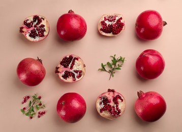 Photo of Flat lay composition with ripe pomegranates on beige background