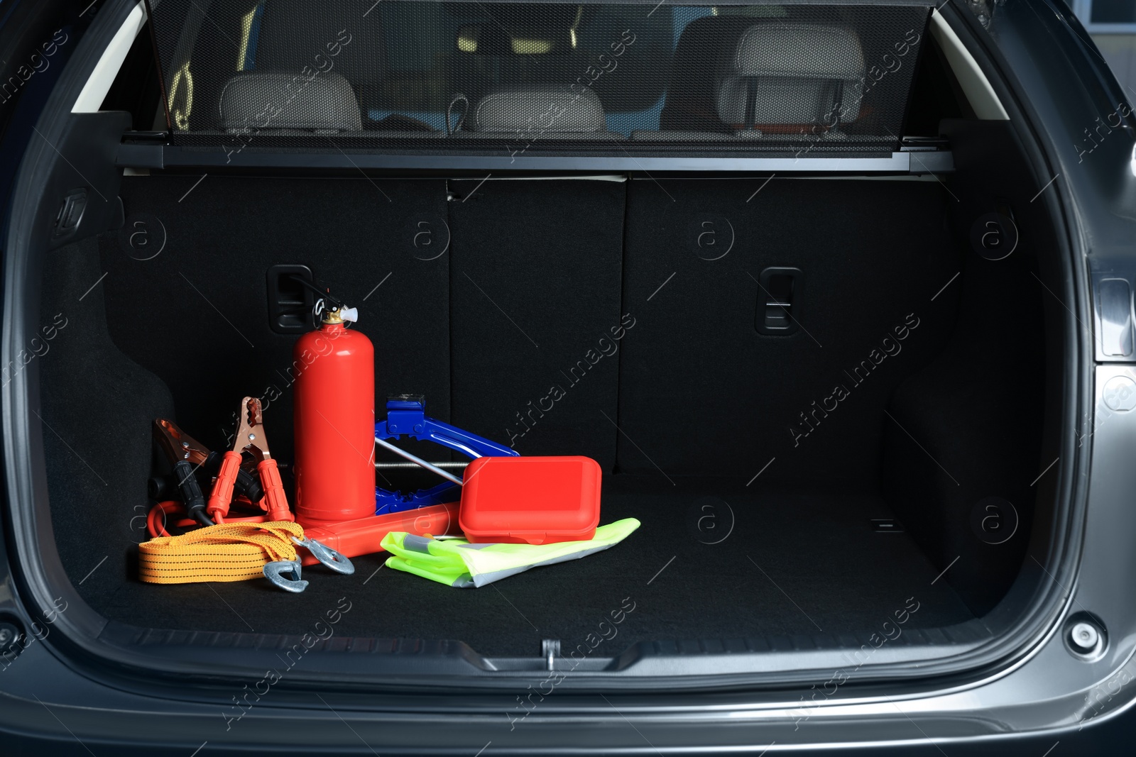 Photo of Set of car safety equipment in trunk, space for text