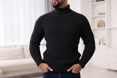 Photo of Man in stylish sweater at home, closeup