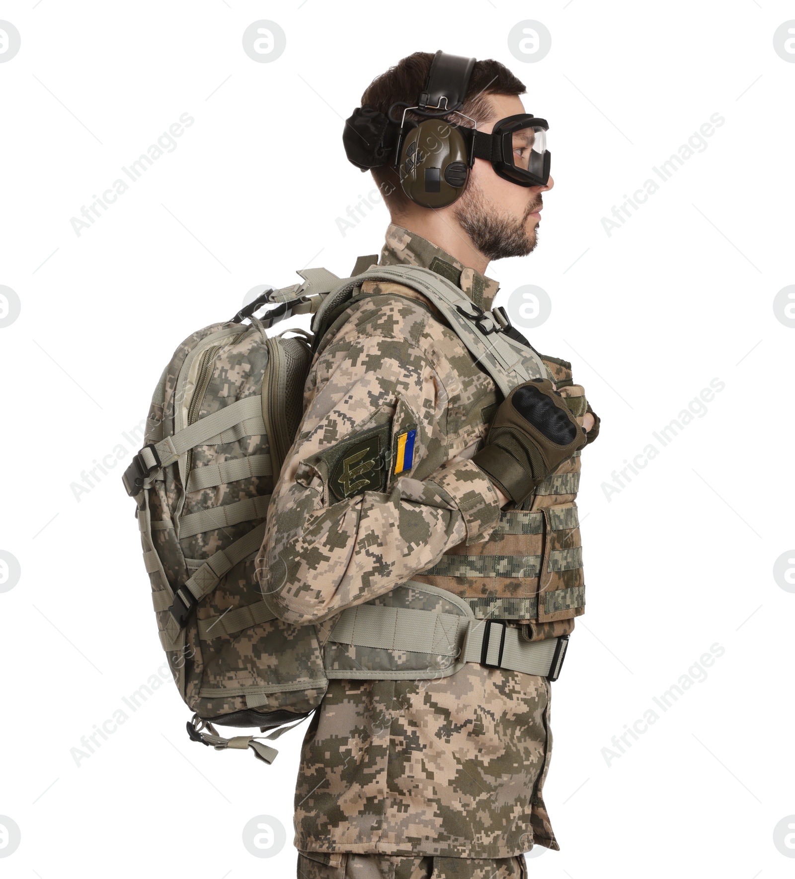 Photo of Soldier in Ukrainian military uniform and tactical goggles with backpack on white background