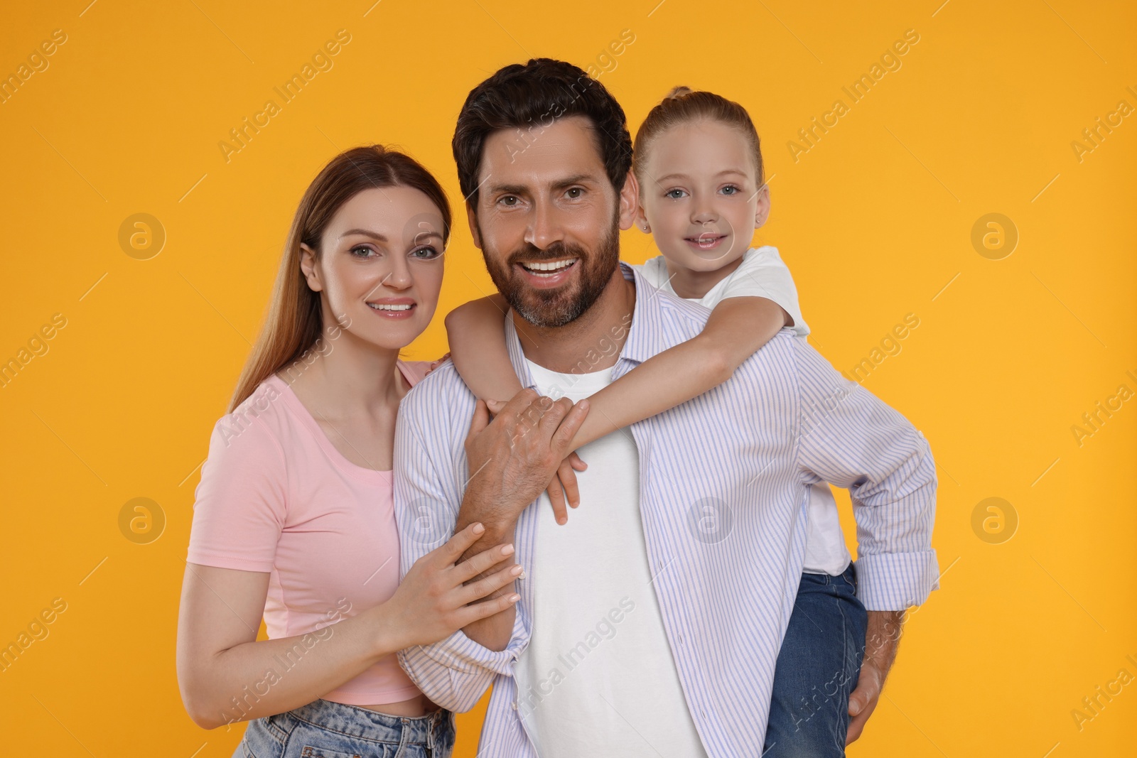 Photo of Portrait of happy family on orange background