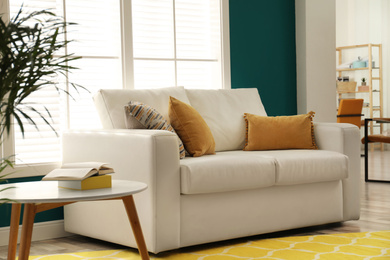 Photo of Modern comfortable sofa in stylish home interior