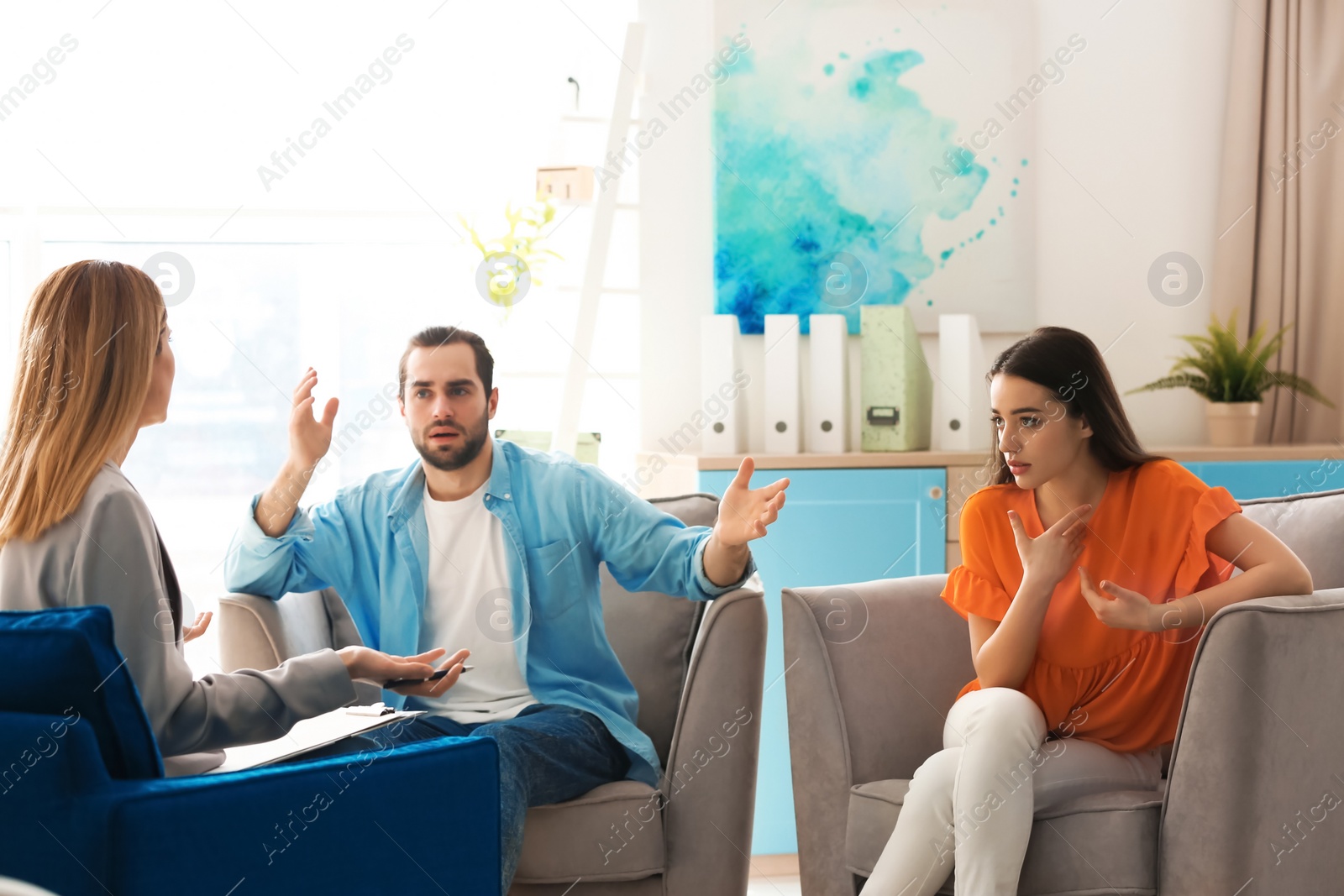 Photo of Family psychologist working with young couple in office