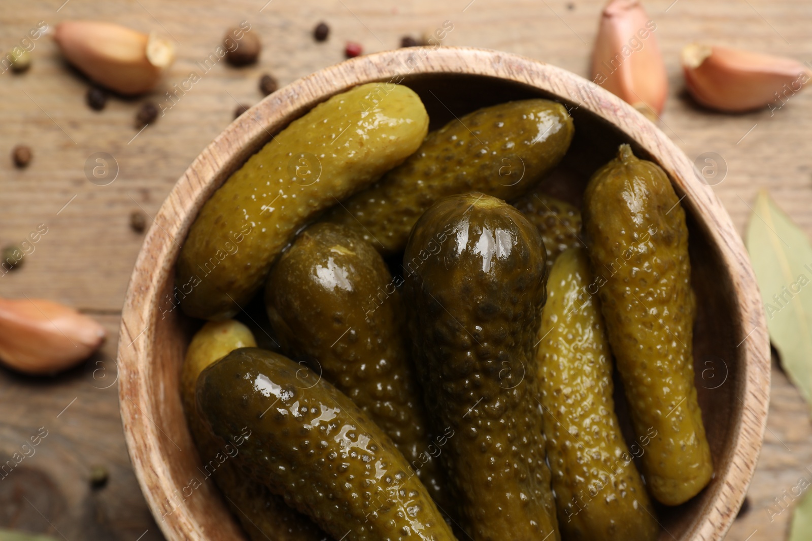 Photo of Tasty pickled cucumbers in bowl on table, top view