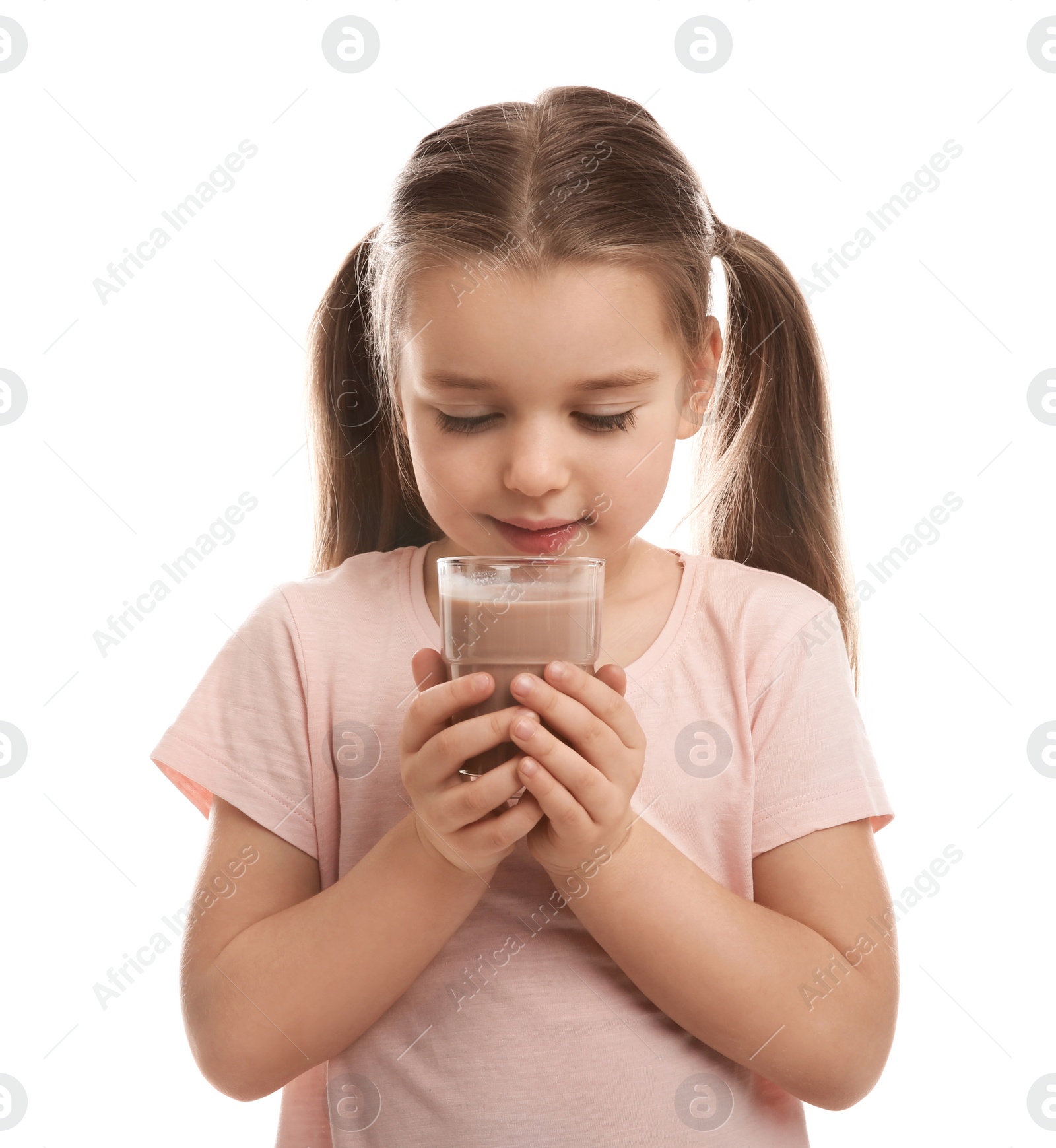 Photo of Cute little child drinking tasty chocolate milk on white background