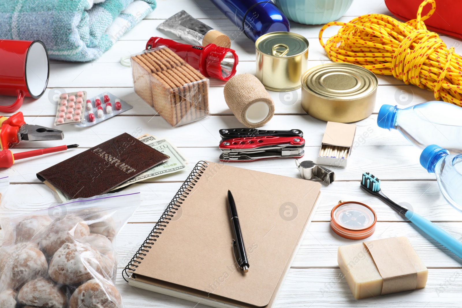 Photo of Disaster supply kit for earthquake on white wooden table