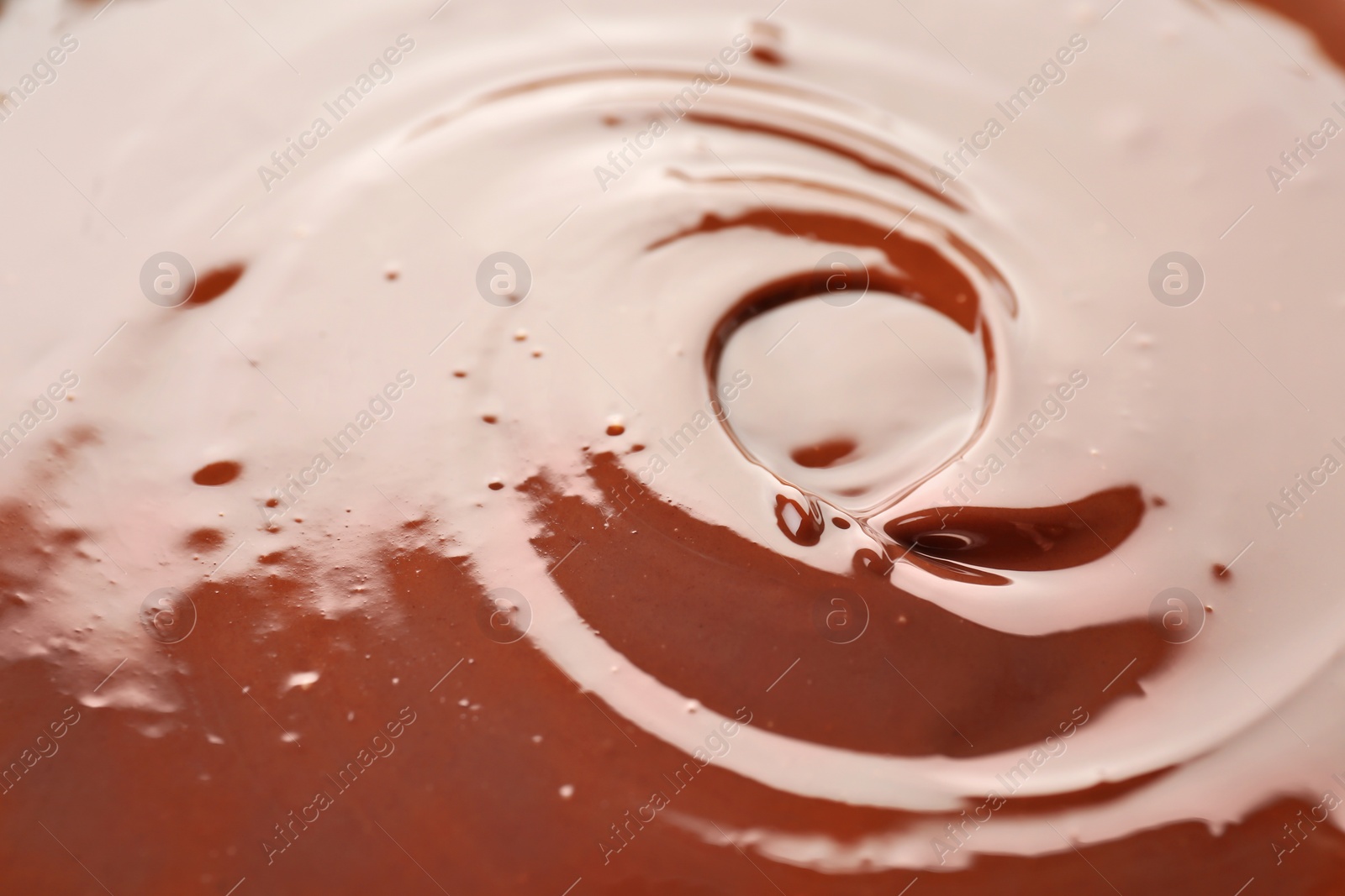 Photo of Delicious melted milk chocolate, closeup