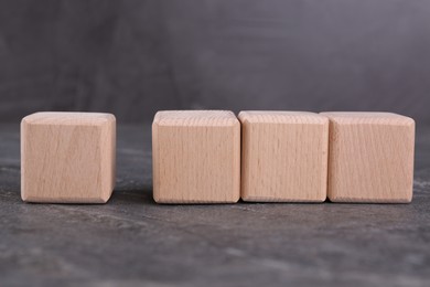 Cubes with check mark and abbreviation ISO on gray textured table