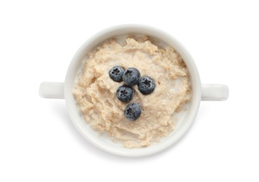 Photo of Tasty oatmeal porridge with blueberries in bowl on white background, top view