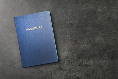 Photo of Blank blue passport on dark grey table, top view with space for text