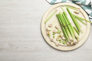 Photo of Fresh lemongrass on white wooden table, flat lay. Space for text