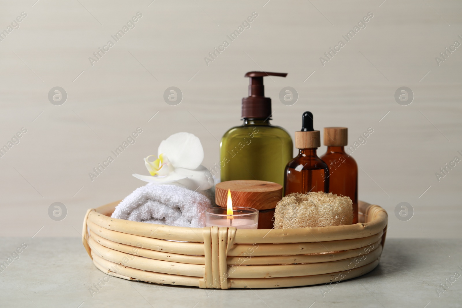 Photo of Beautiful composition with different spa products and burning candle on light table