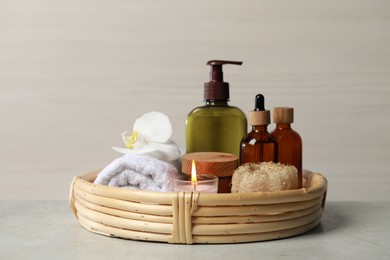 Photo of Beautiful composition with different spa products and burning candle on light table