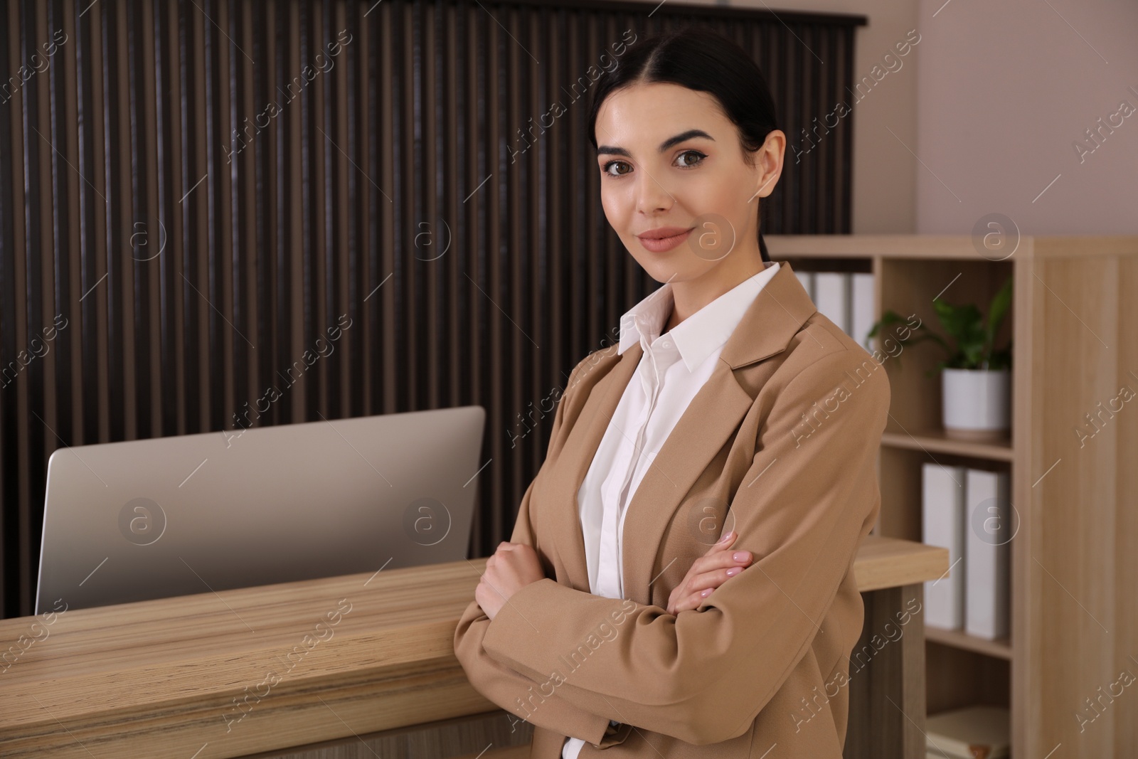 Photo of Portrait of receptionist near countertop in office, space for text