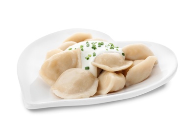 Delicious cooked dumplings with sour cream on white background