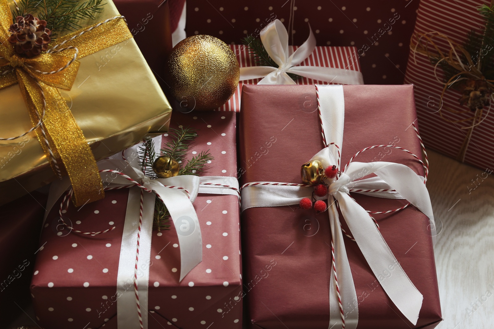 Photo of Pile of different Christmas gifts on floor indoors