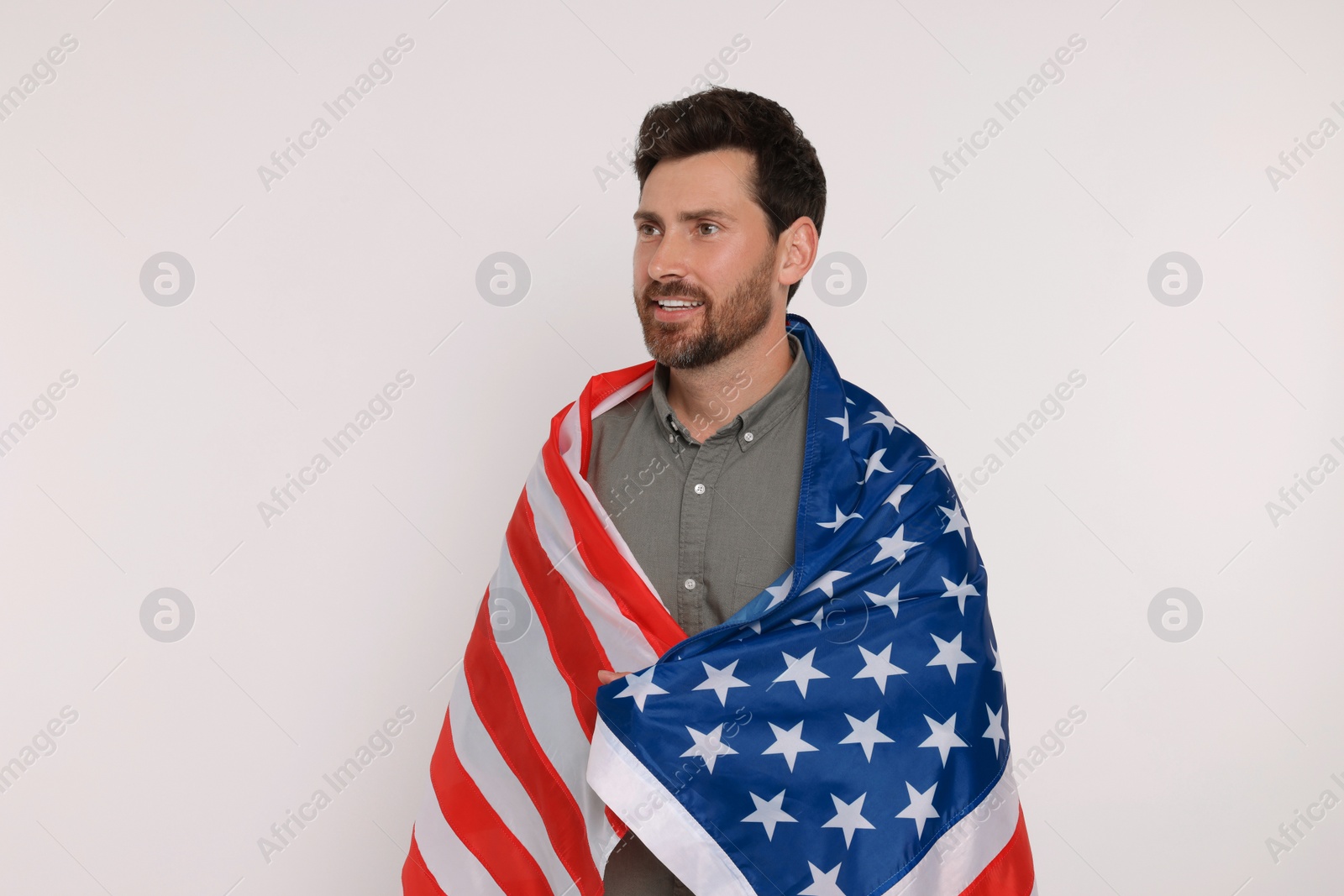 Photo of 4th of July - Independence Day of USA. Happy man with American flag on white background