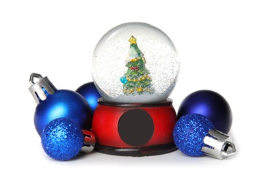 Photo of Magical snow globe with Christmas balls on white background