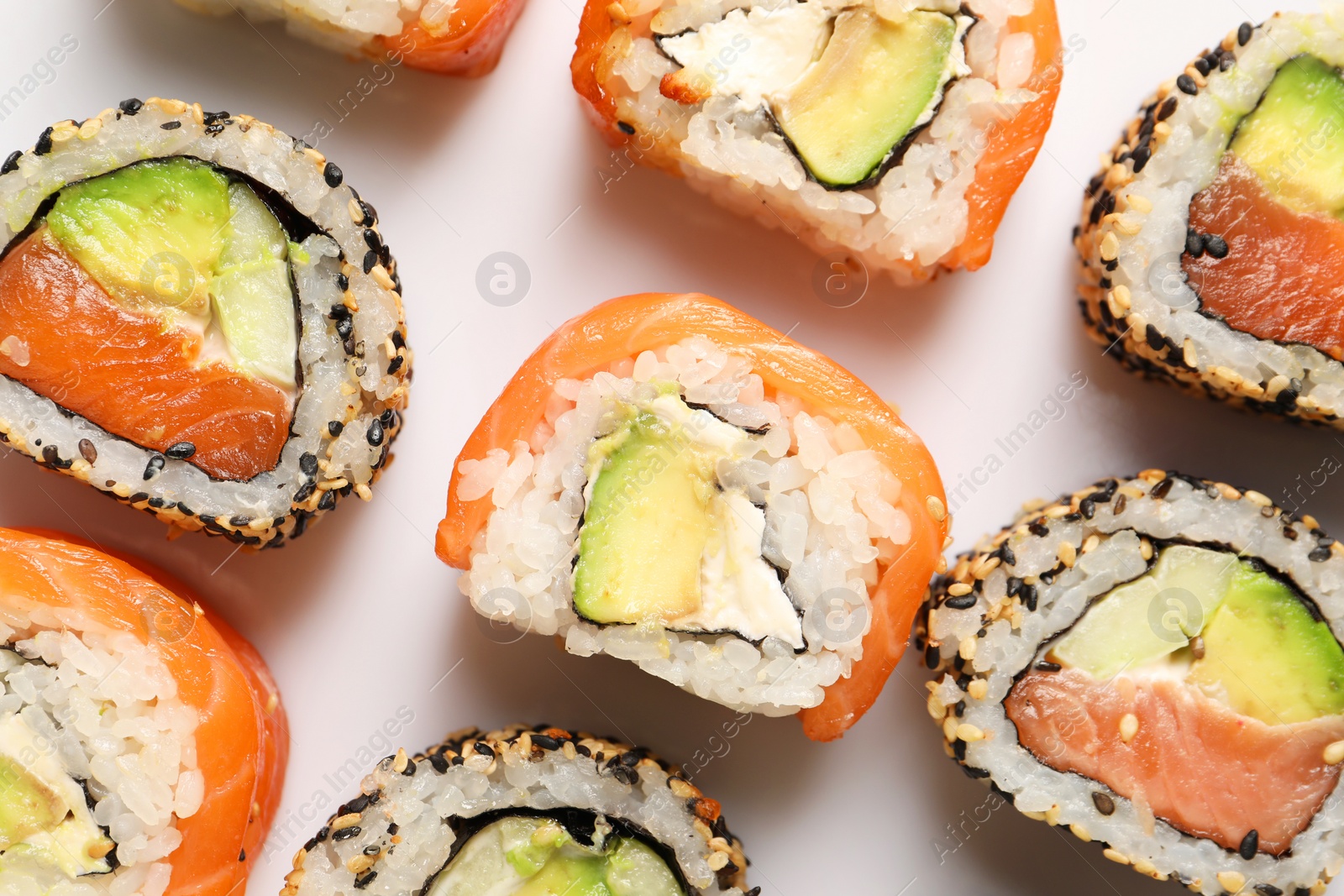 Photo of Delicious sushi rolls on white background, flat lay