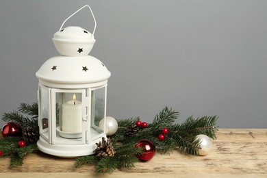 Photo of Lantern and Christmas decorations on grey background, space for text