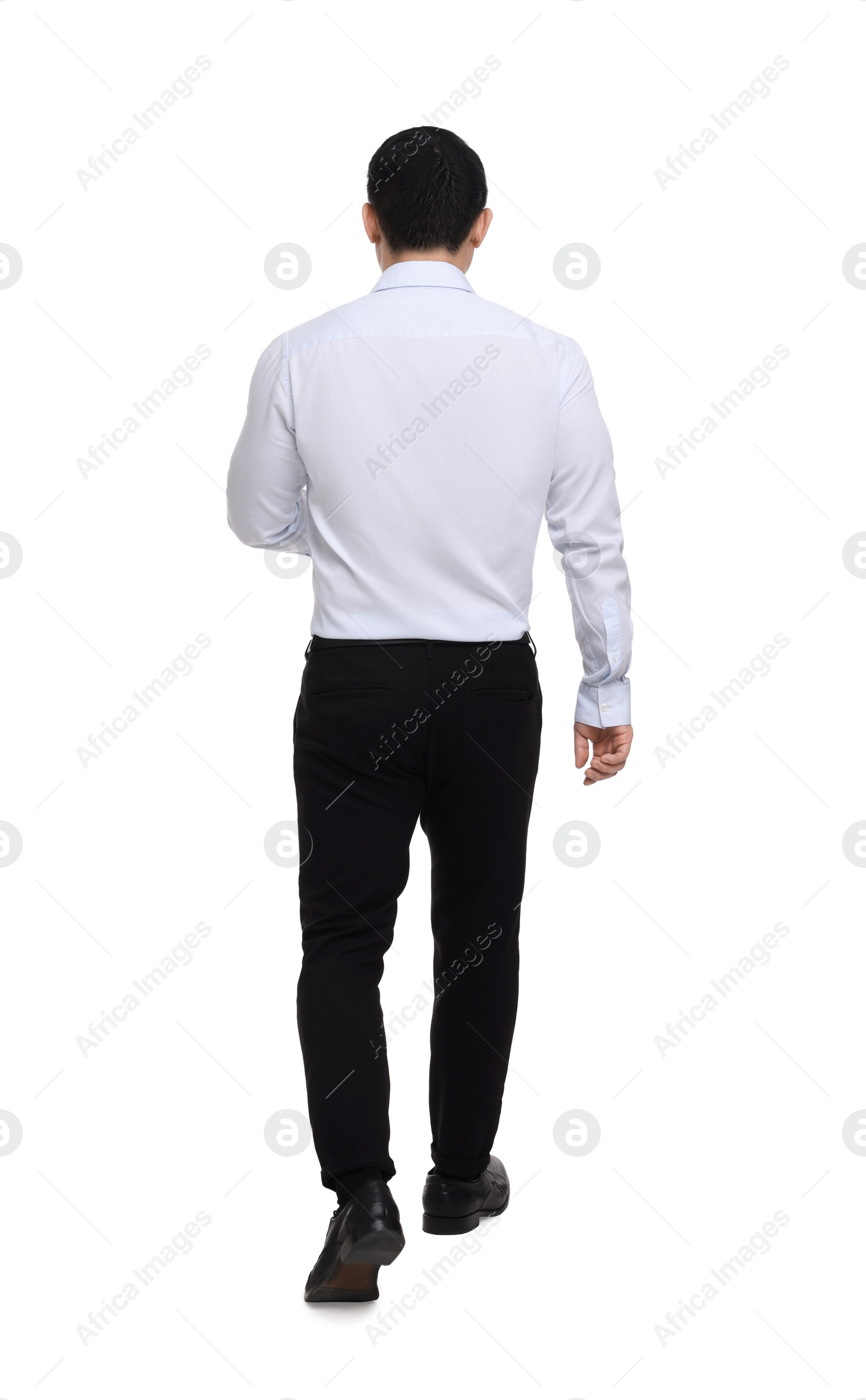 Photo of Businessman in formal clothes walking on white background, back view