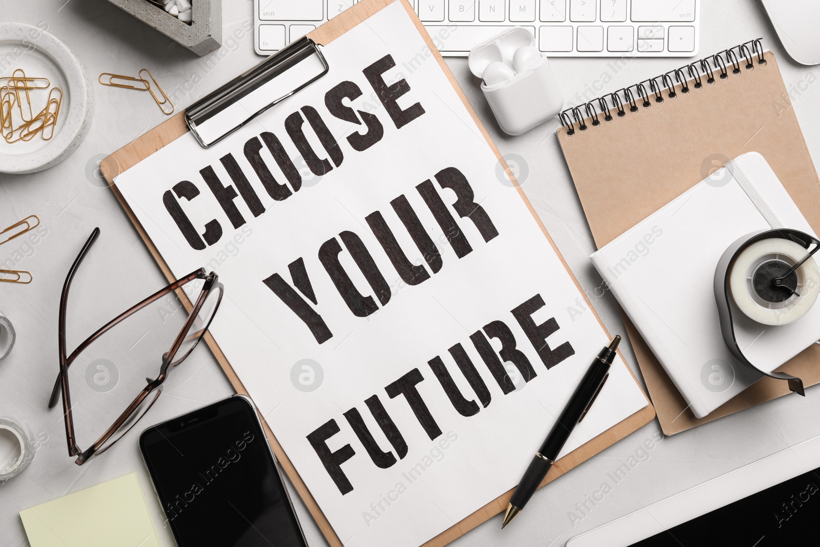 Photo of Flat lay composition with words CHOOSE YOUR FUTURE, computer keyboard and stationery on white table. Career concept