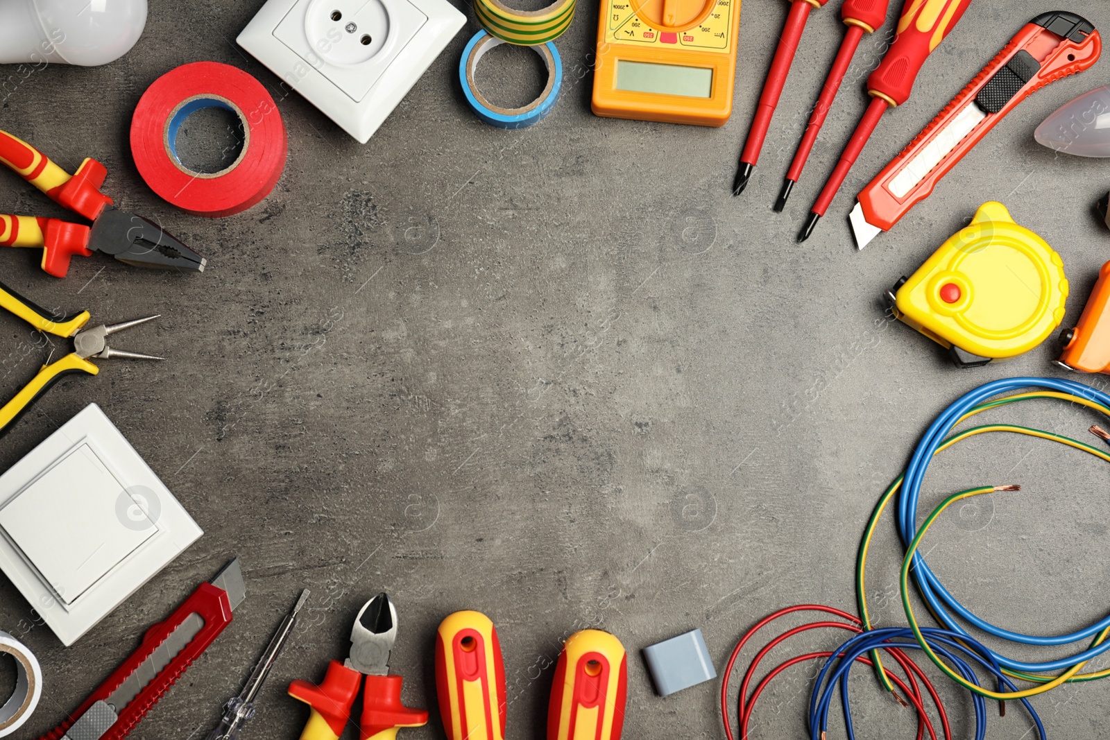 Photo of Flat lay composition with electrician's tools and space for text on gray background