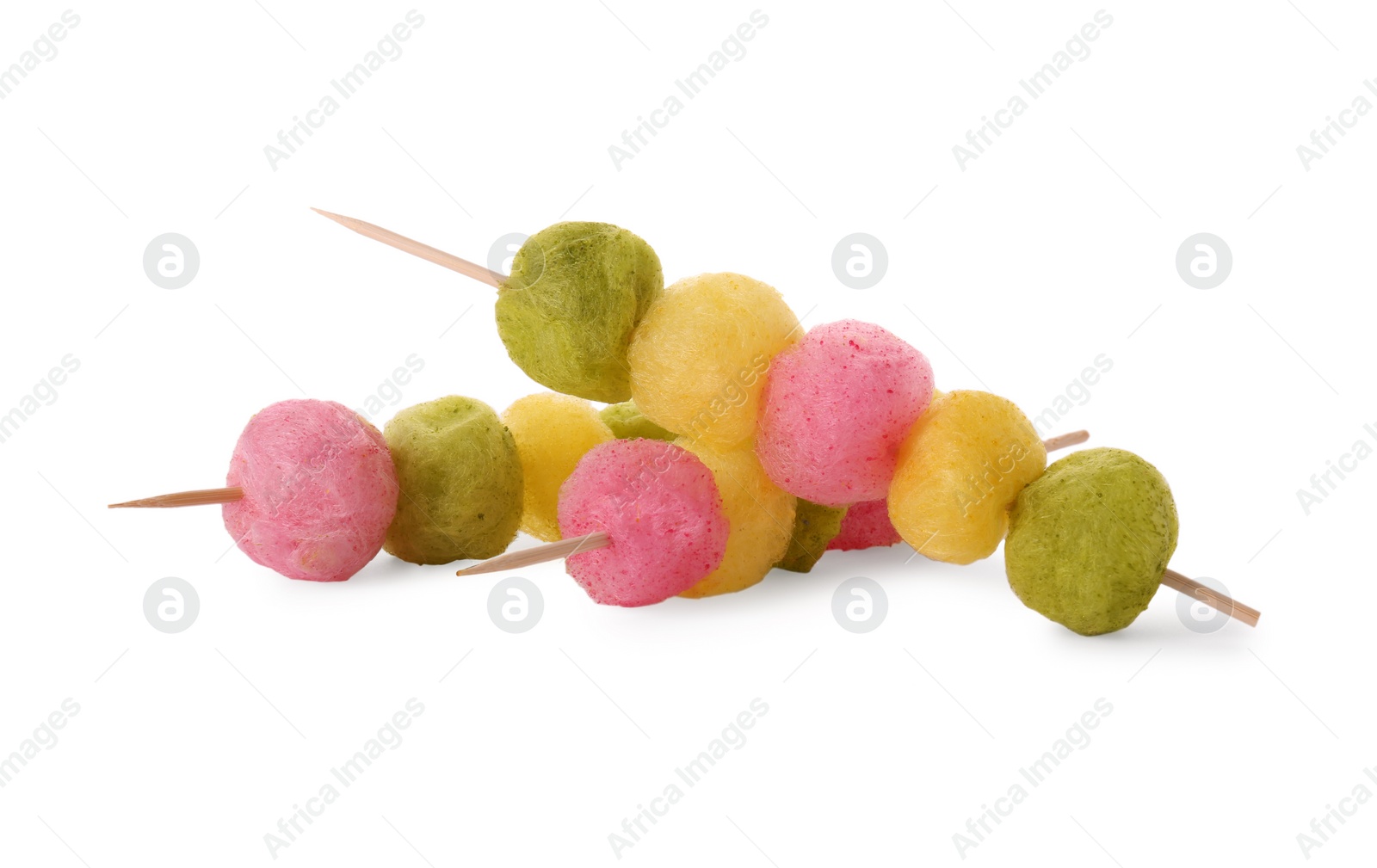 Photo of Skewers with color cotton balls isolated on white. Sweet candy