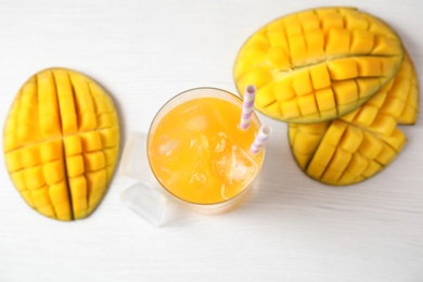 Fresh mango drink and fruits on table, top view