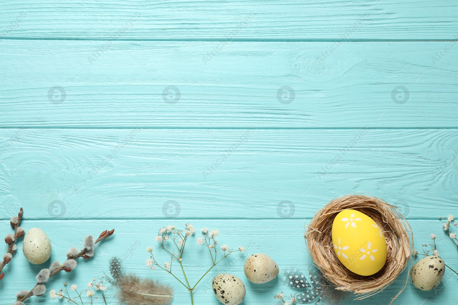 Photo of Flat lay composition with Easter eggs on light blue wooden background. Space for text