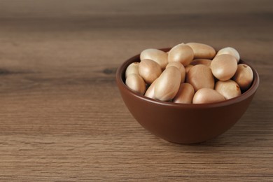 Raw jackfruit seeds on wooden table. Space for text