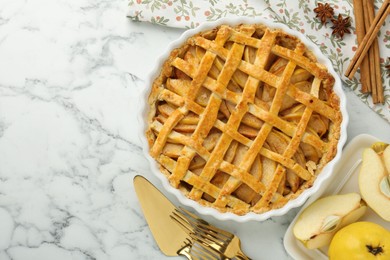 Photo of Tasty homemade quince pie served on white marble table, flat lay. Space for text