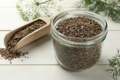 Dry seeds and fresh dill on white wooden table, selective focus. Space for text