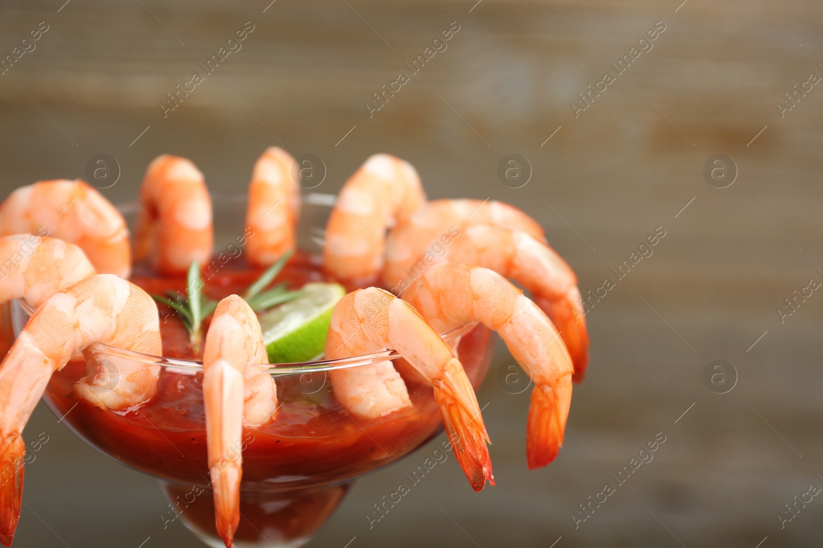 Photo of Delicious shrimp cocktail with tomato sauce, closeup