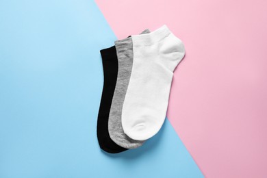 Different socks on colorful background, flat lay