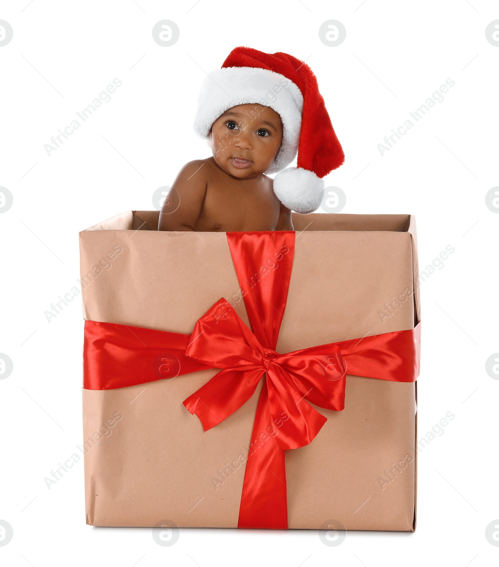 Photo of Cute African-American baby wearing Santa hat in Christmas gift box on white background