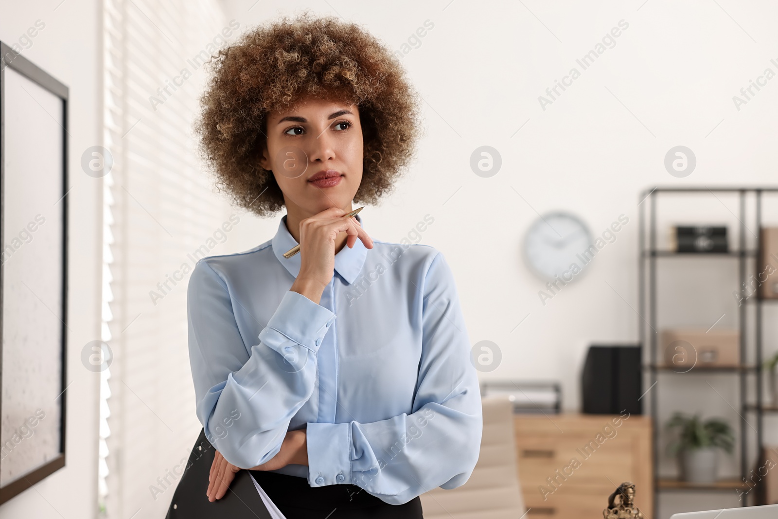 Photo of Notary with clipboard and pen in office