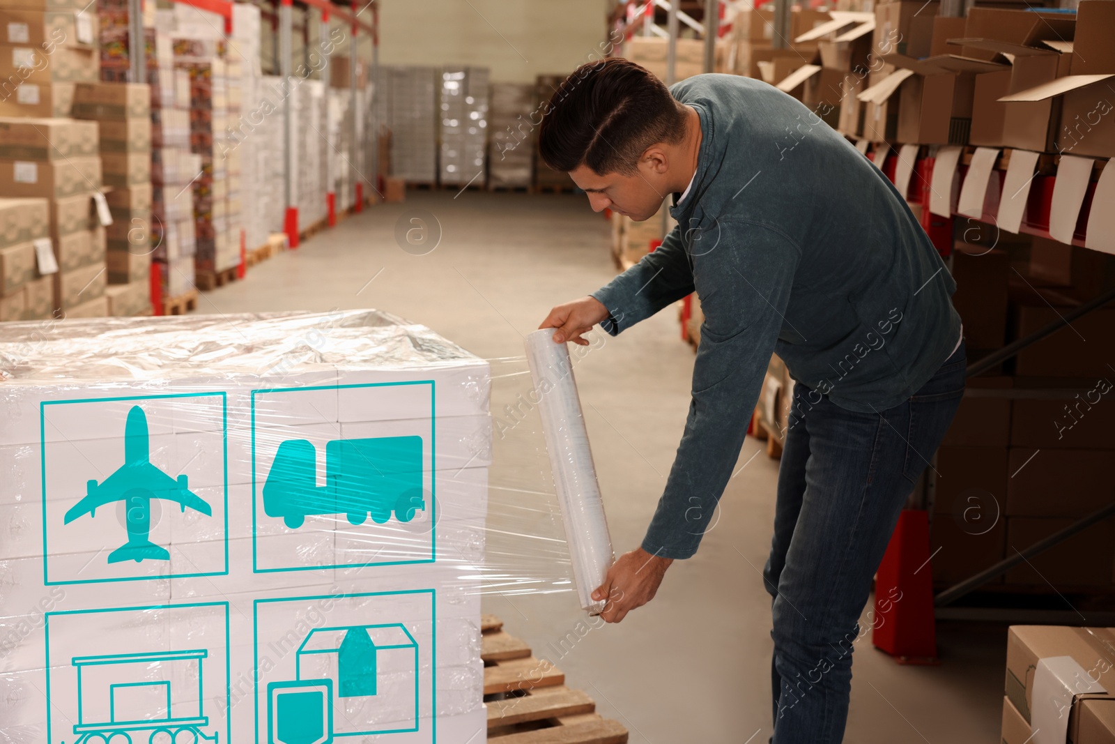 Image of Worker wrapping boxes with shipping icons in stretch film at warehouse