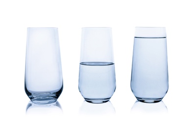 Empty, half and full glasses of water on white background