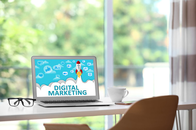 Image of Digital marketing concept. Modern laptop on table indoors