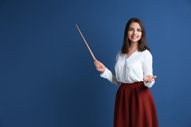 Photo of Portrait of female teacher with pointer on color background