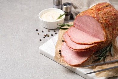 Photo of Delicious ham served on grey table. Space for text
