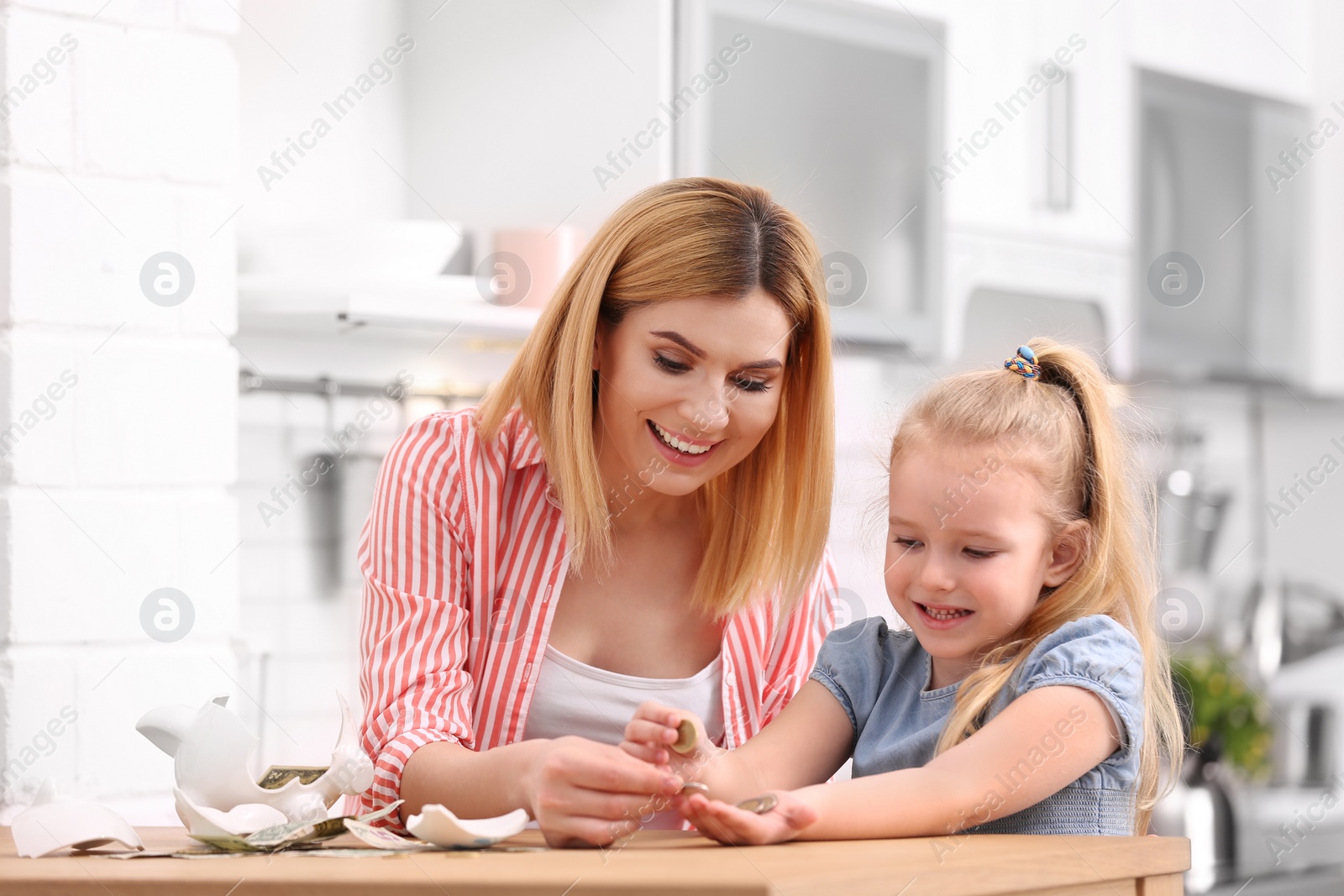 Photo of Family with broken piggy bank and money at home