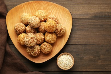 Photo of Delicious sesame balls on wooden table, flat lay. Space for text