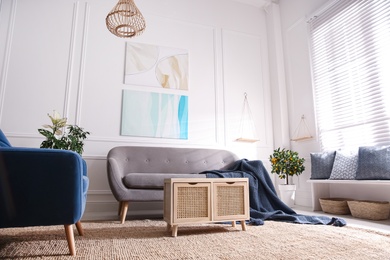 Photo of Beautiful living room interior with comfortable gray sofa