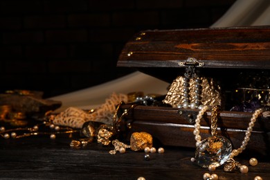 Photo of Wooden chest with treasures on floor, space for text