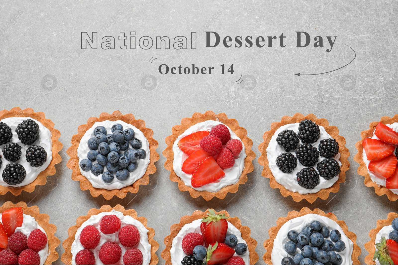 Image of National Dessert Day, October 14. Tasty tartlets with different fresh berries on light grey table, flat lay