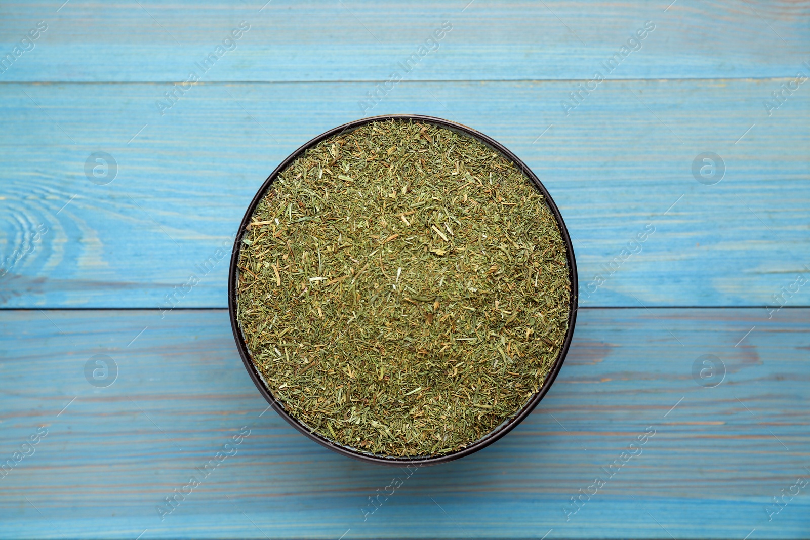 Photo of Dried dill on turquoise wooden table, top view